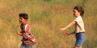 boy and girl running in field