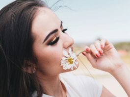 woman smelling flower