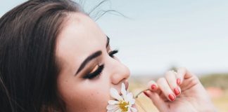 woman smelling flower