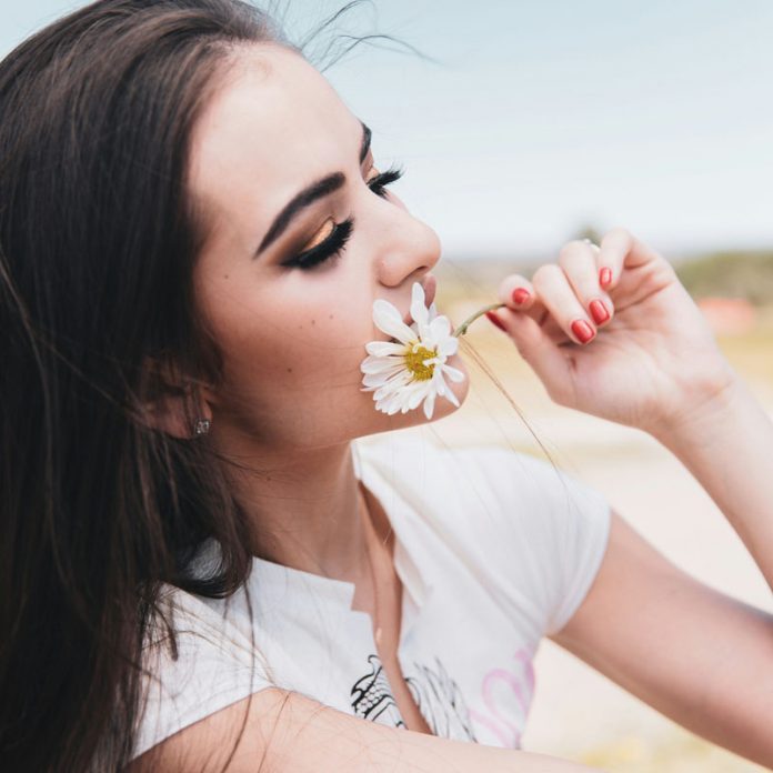 woman smelling flower