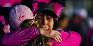 two woman hugging at a susan g komen 3 day