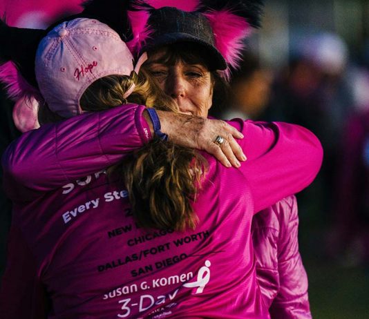 two woman hugging at a susan g komen 3 day