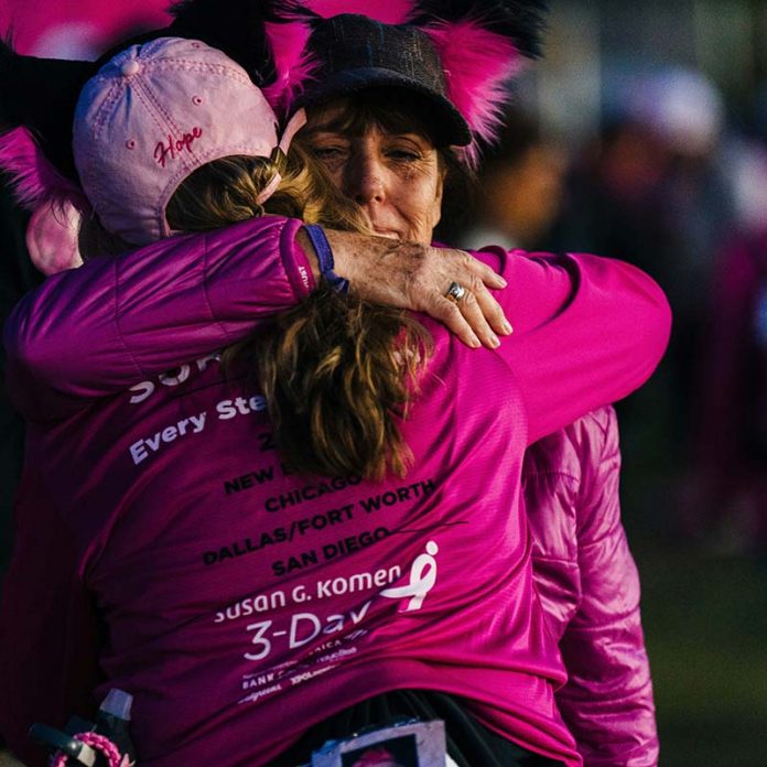 two woman hugging at a susan g komen 3 day